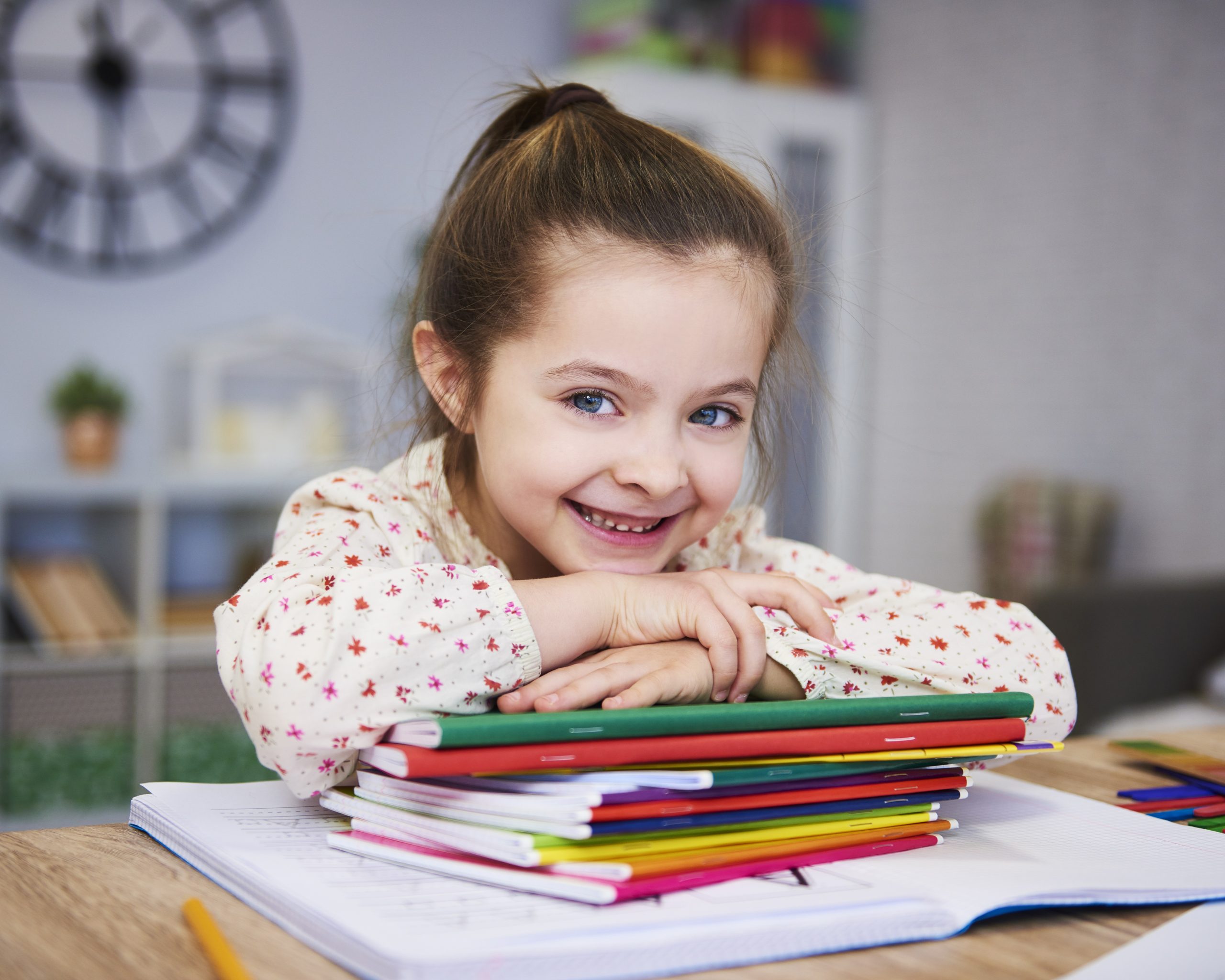 Smiling girl studying at home